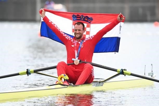 Bronze medalist Croatia's Damir Martin poses in his boat following the men's single sculls final during the Tokyo 2020 Olympic Games at the Sea...