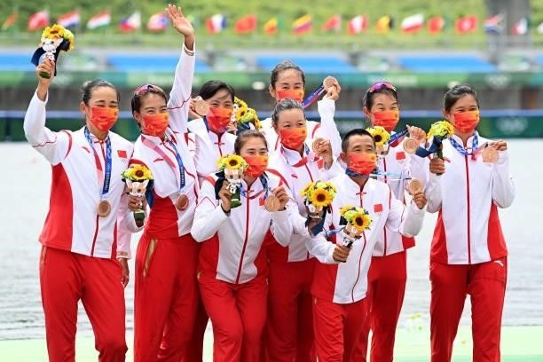 Bronze medalists China's Zifeng Wang, Yuwei Wang, Fei Xu, Tian Miao, Min Zhang, Rui Ju, Jingjing Li, Linlin Guo and coxswain Dechang Zhang on the...