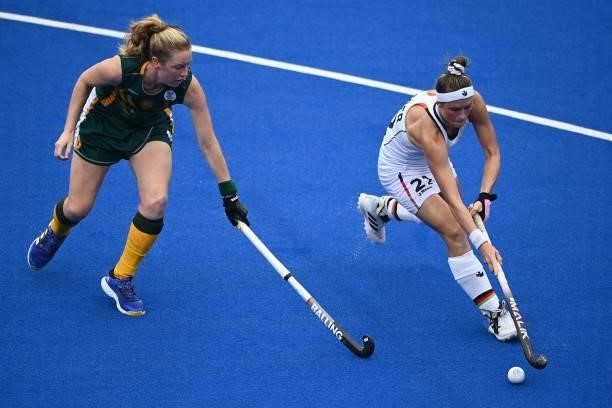 South Africa's Taryn Mallett and Germany's Cecile Pieper vie for the ball during their women's pool A match of the Tokyo 2020 Olympic Games field...
