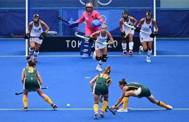 Players of South Africa take a penalty corner against Germany during their women's pool A match of the Tokyo 2020 Olympic Games field hockey...