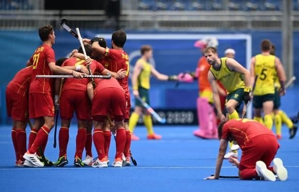 Players of Spain celebrate during their men's pool A match of the Tokyo 2020 Olympic Games field hockey competition against Australia, at the Oi...