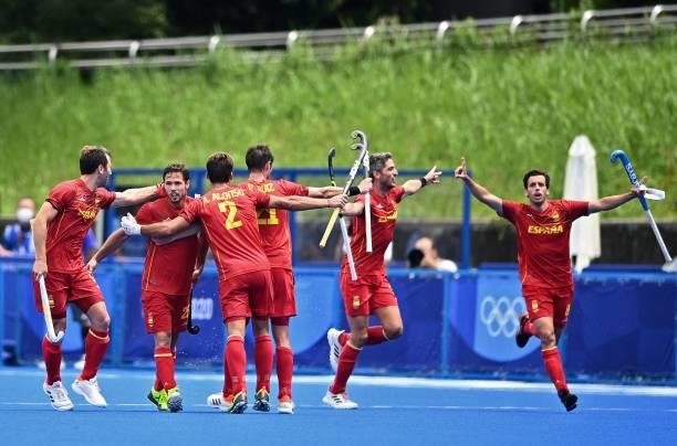 Spain's Pau Quemada celebrates with teammates after scoring against Australia during their men's pool A match of the Tokyo 2020 Olympic Games field...