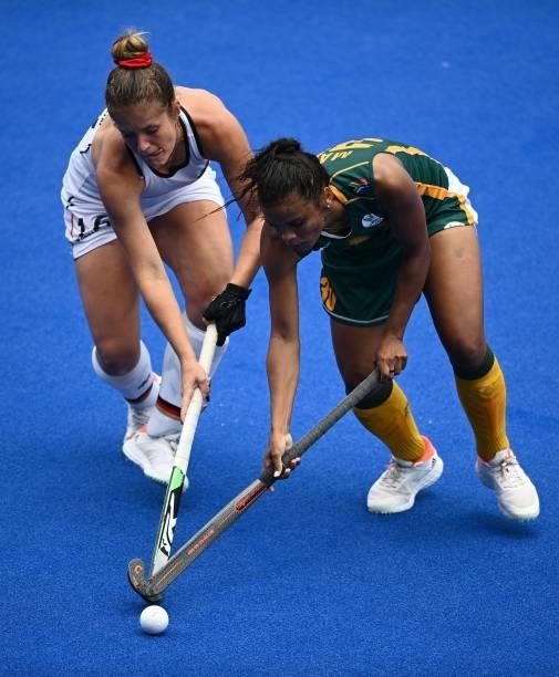 Germany's Sonja Zimmermann and South Africa's Toni Marks vie for the ball during their women's pool A match of the Tokyo 2020 Olympic Games field...