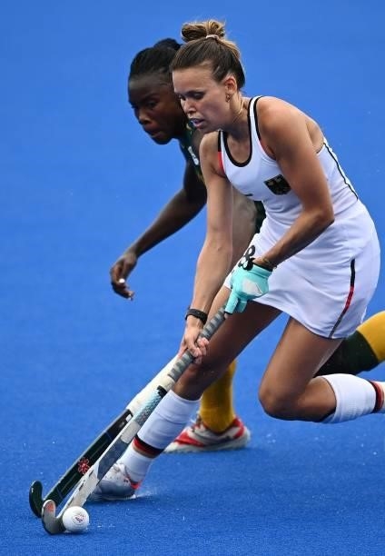 Germany's Anne Katarina Schroder is marked by South Africa's Onthatile Zulu during their women's pool A match of the Tokyo 2020 Olympic Games field...