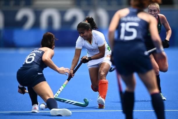 India's Neha is tackled by Ireland's Anna O'Flanagan during their women's pool A match of the Tokyo 2020 Olympic Games field hockey competition, at...