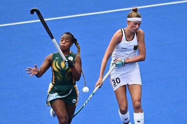 South Africa's Edith Molikoe and Germany's Hanna Carina Granitzki vie for the ball during their women's pool A match of the Tokyo 2020 Olympic Games...