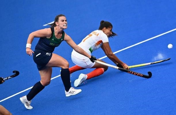 Ireland's Lizzy Holden and India's Sharmila Devi vie for the ball during their women's pool A match of the Tokyo 2020 Olympic Games field hockey...