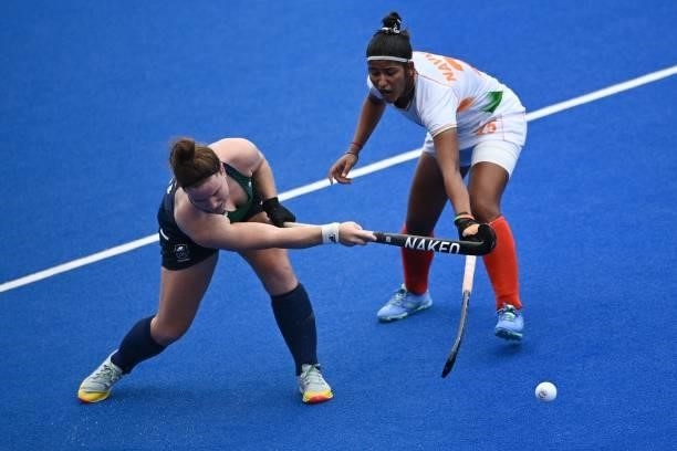 Ireland's Shirley McCay and India's Navneet Kaur vie for the ball during their women's pool A match of the Tokyo 2020 Olympic Games field hockey...