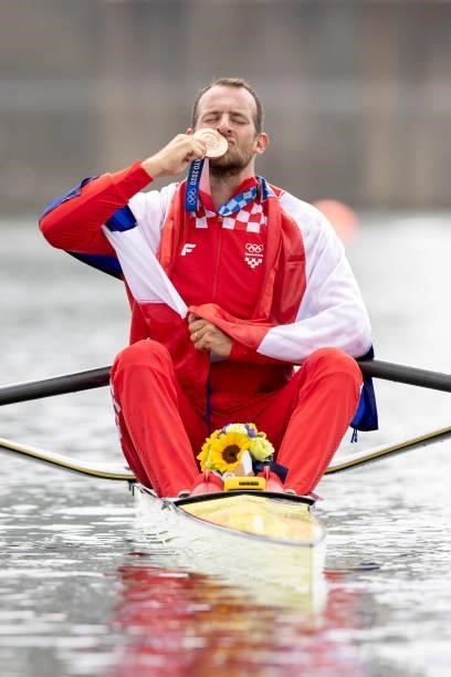 Damir Martin of Croatia celebrates on his boat with his bronze medal after finishing third in the Men's Single Sculls Final A at the Sea Forest...