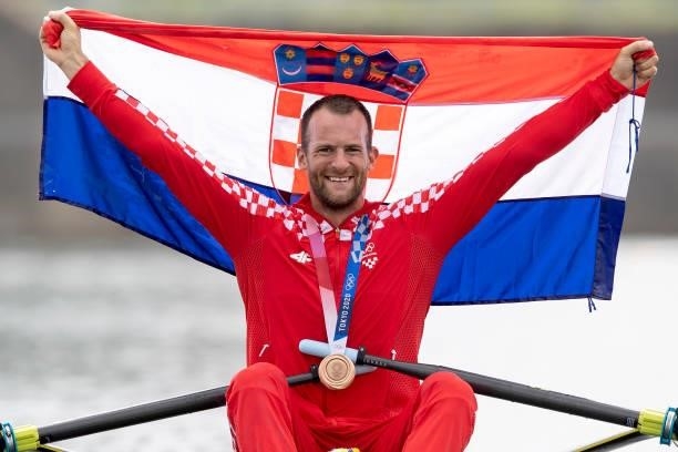 Damir Martin of Croatia celebrates on his boat with his bronze medal after finishing third in the Men's Single Sculls Final A at the Sea Forest...