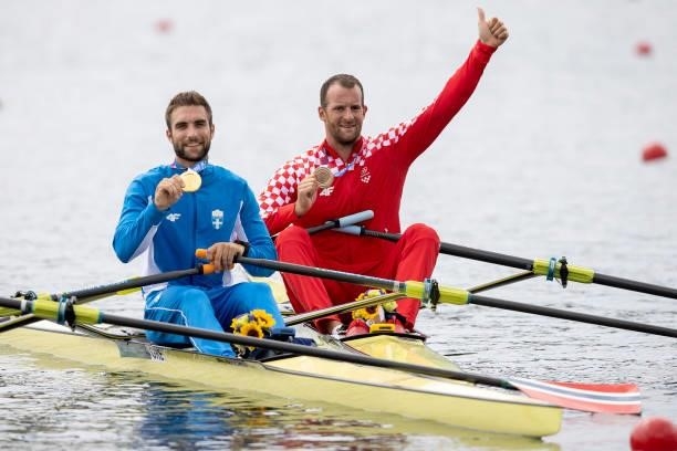 Gold medalist Stefanos Ntouskos of Team Greece and bronze medalist Damir Martin of Team Croatia pose with their medals on their boats after the Men's...