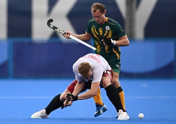 Canada's Gordon Mackenzi Johnston and South Africa's Nicholas Balfour Spooner vie for the ball during their men's pool B match of the Tokyo 2020...