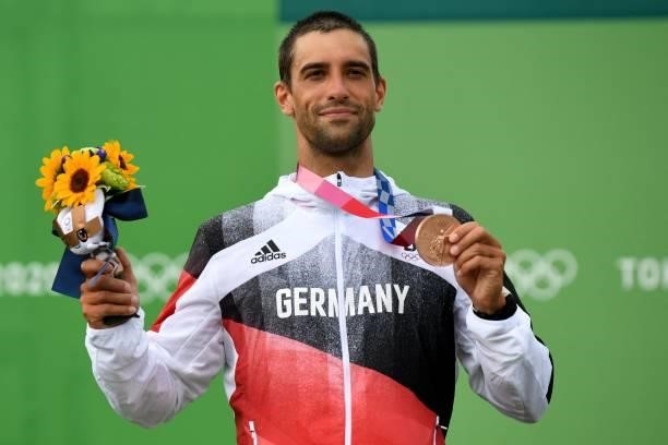 Bronze medalist Germany's Hannes Aigner poses on the podium following the men's Kayak final during the Tokyo 2020 Olympic Games at Kasai Canoe Slalom...