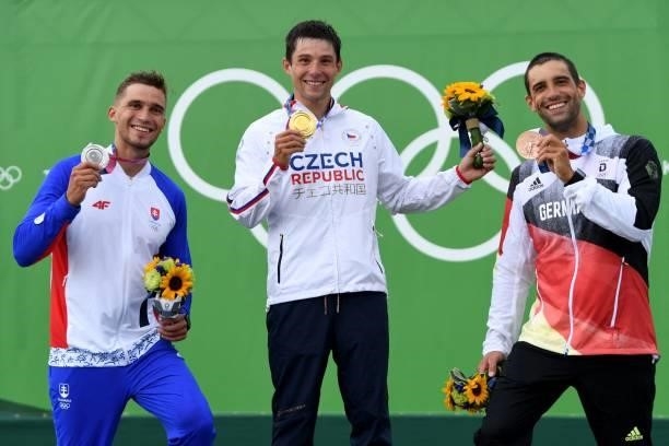 Silver medalist Slovakia's Jakub Grigar, gold medalist Czech Republic's Jiri Prskavec and bronze medalist Germany's Hannes Aigner pose on the podium...
