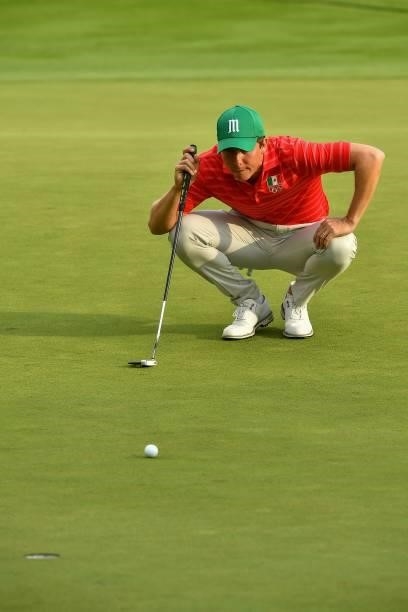 Mexico's Carlos Ortiz sets up his putt on the 18th green in round 2 of the mens golf individual stroke play during the Tokyo 2020 Olympic Games at...