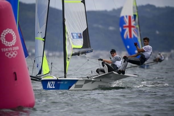 New-Zealand's Blair Tuke and Peter Burling compete in the men's skiff 49er race during the Tokyo 2020 Olympic Games sailing competition at the...