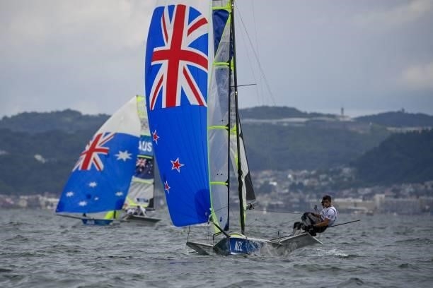 New-Zealand's Blair Tuke and Peter Burling compete in the men's skiff 49er race during the Tokyo 2020 Olympic Games sailing competition at the...