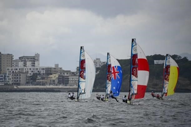 Competitors take part in the women's skiff 49er FX race during the Tokyo 2020 Olympic Games sailing competition at the Enoshima Yacht Harbour in...