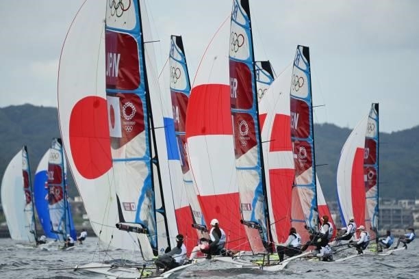 Competitors take part in the women's skiff 49er FX race during the Tokyo 2020 Olympic Games sailing competition at the Enoshima Yacht Harbour in...