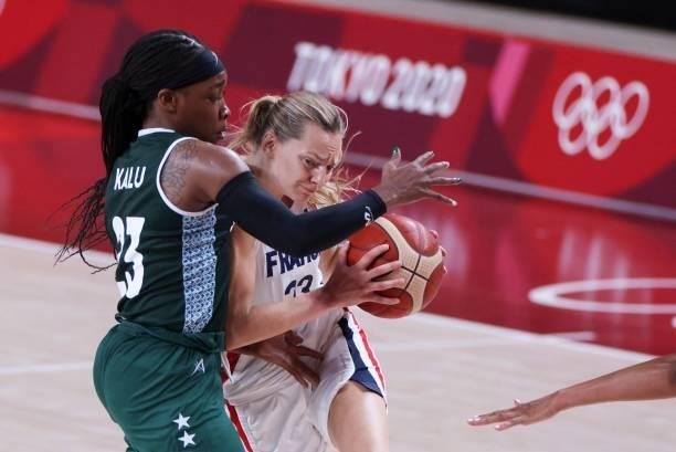 France's Marine Johannes dribbles the ball past Nigeria's Ezinne Kalu in the women's preliminary round group B basketball match between France and...
