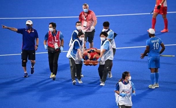 Japan's Shota Yamada is taken out of the pitch on a stretcher during the men's pool A match of the Tokyo 2020 Olympic Games field hockey competition...