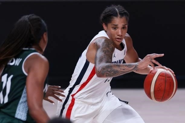 France's Gabrielle Williams goes to the basket past Nigeria's Promise Amukamara in the women's preliminary round group B basketball match between...