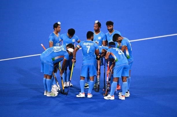 Players of India talk during the men's pool A match of the Tokyo 2020 Olympic Games field hockey competition against Japan, at the Oi Hockey Stadium...