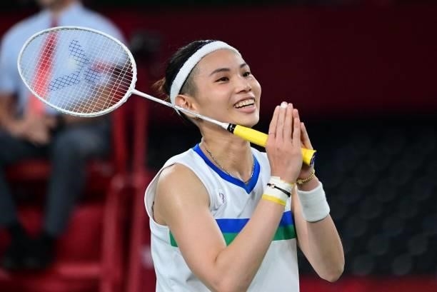 Taiwan's Tai Tzu-ying celebrates after beating Thailand's Ratchanok Intanon in their women's singles badminton quarter final match during the Tokyo...