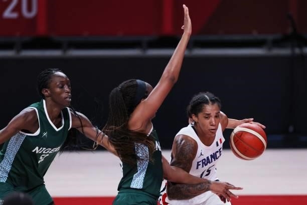 France's Gabrielle Williams goes to the basket past Nigeria's Promise Amukamara in the women's preliminary round group B basketball match between...