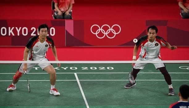 Indonesia's Mohammad Ahsan and Indonesia's Hendra Setiawan watch the shuttlecock during their men's doubles badminton semi-final match against...