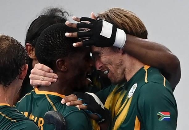 South Africa's Samkelo Mvimbi celebrates with teammate Taine Paton after scoring against Canada during their men's pool B match of the Tokyo 2020...