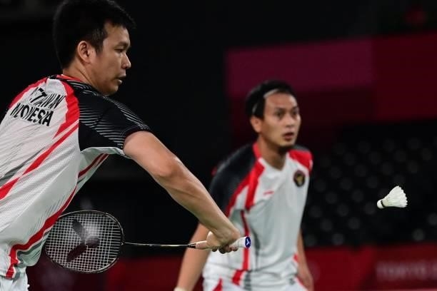 Indonesia's Hendra Setiawan hits a shot next to Indonesia's Mohammad Ahsan in their men's doubles badminton semi-final match against Taiwan's Wang...