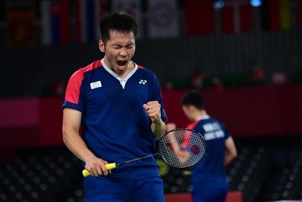 Taiwan's Lee Yang reacts after a point with Taiwan's Wang Chi-lin in their men's doubles badminton semi-final match against Indonesia's Mohammad...