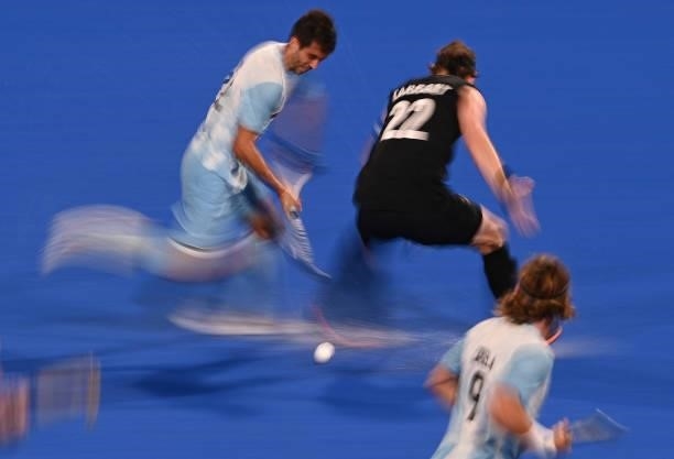 Argentina's Matias Alejandro Rey is tackled by New Zealand's Blair Tarrant during their men's pool A match of the Tokyo 2020 Olympic Games field...