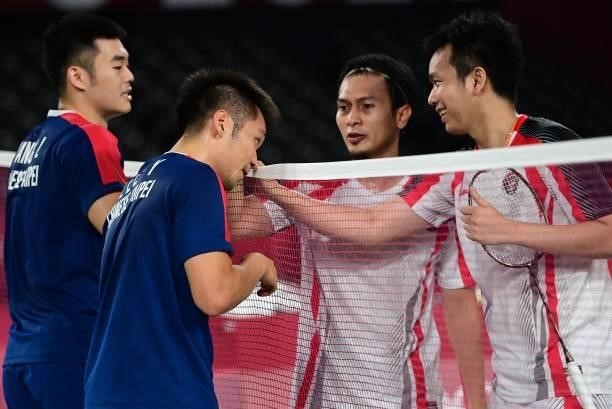 Taiwan's Lee Yang and Taiwan's Wang Chi-lin greet Indonesia's Mohammad Ahsan and Indonesia's Hendra Setiawan after winning their men's doubles...