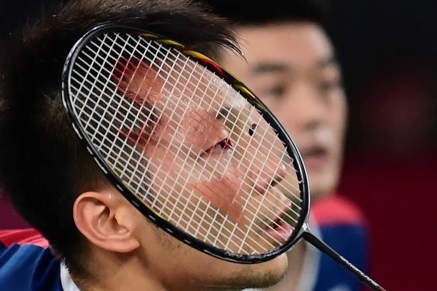 Taiwan's Lee Yang prepares to hit a shot next to Taiwan's Wang Chi-lin in their men's doubles badminton semi-final match against Indonesia's Mohammad...