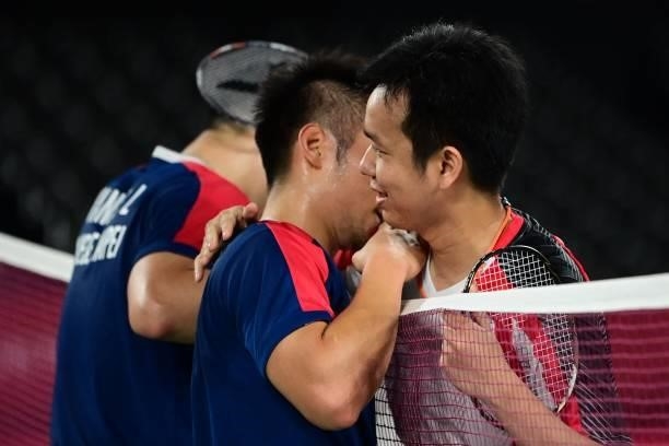 Taiwan's Lee Yang hugs Indonesia's Mohammad Ahsan after Yang and partner Wang Chi-lin won their men's doubles badminton semi-final match against...