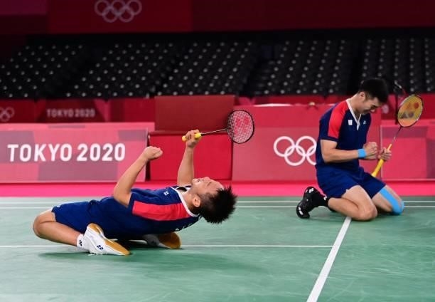 Taiwan's Lee Yang and Taiwan's Wang Chi-lin celebrate winning their men's doubles badminton semi-final match against Indonesia's Mohammad Ahsan and...