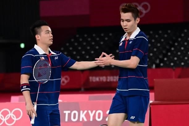 Malaysia's Soh Wooi Yik and Malaysia's Aaron Chia react after a point in their men's doubles badminton semi-final match against China's Liu Yuchen...