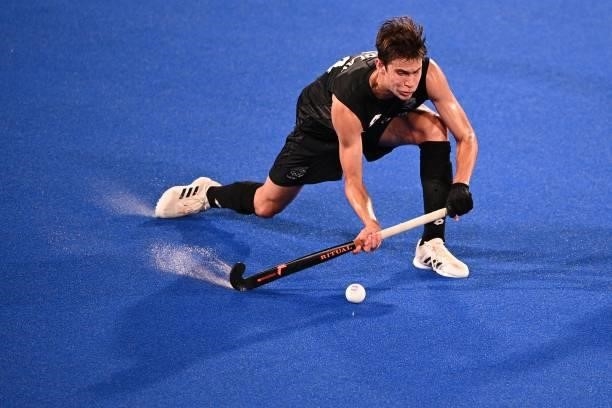 New Zealand's Sean Findlay strikes the ball during the men's pool A match of the Tokyo 2020 Olympic Games field hockey competition against Argentina,...