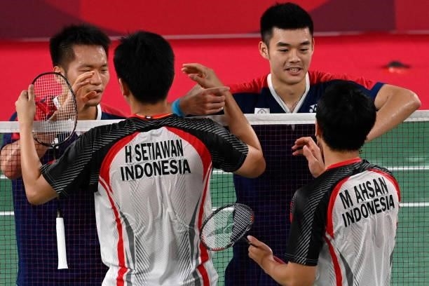 Taiwan's Lee Yang and Taiwan's Wang Chi-lin celebrate winning their men's doubles badminton semi-final match against Indonesia's Mohammad Ahsan and...