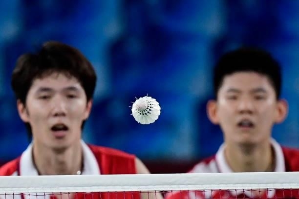 China's Li Junhui and China's Liu Yuchen watch the shuttlecock during their men's doubles badminton semi-final match against Malaysia's Soh Wooi Yik...