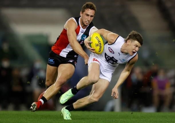 Sam Walsh of the Blues is tackled by Luke Dunstan of the Saints during the 2021 AFL Round 20 match between the St Kilda Saints and the Carlton Blues...