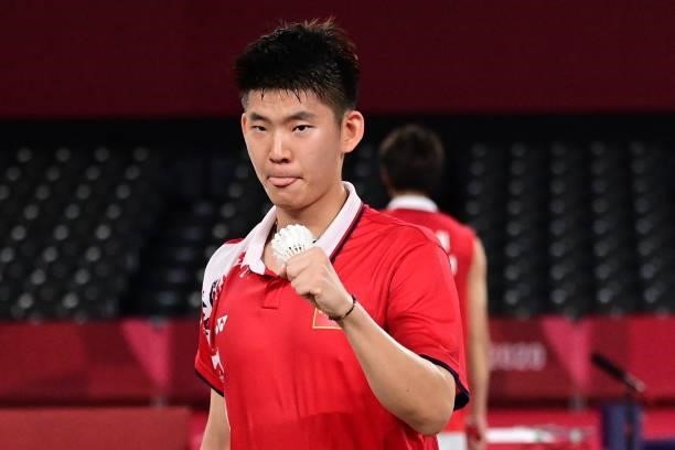 China's Liu Yuchen celebrates next to China's Li Junhui after winning their men's doubles badminton semi-final match against Malaysia's Soh Wooi Yik...