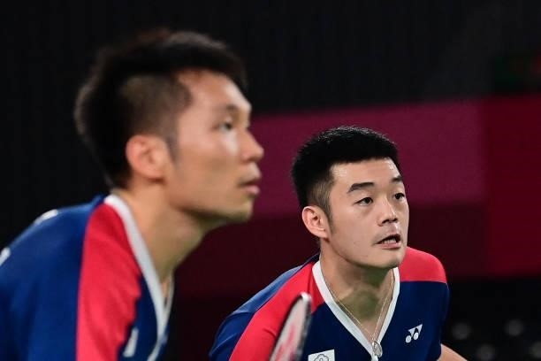 Taiwan's Lee Yang looks on during a point next to Taiwan's Wang Chi-lin in their men's doubles badminton semi-final match against Indonesia's...