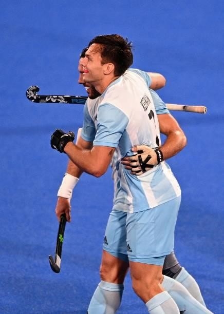 Argentina's Nicolas Santiago Keenan celebrates with a teammate during the men's pool A match of the Tokyo 2020 Olympic Games field hockey competition...