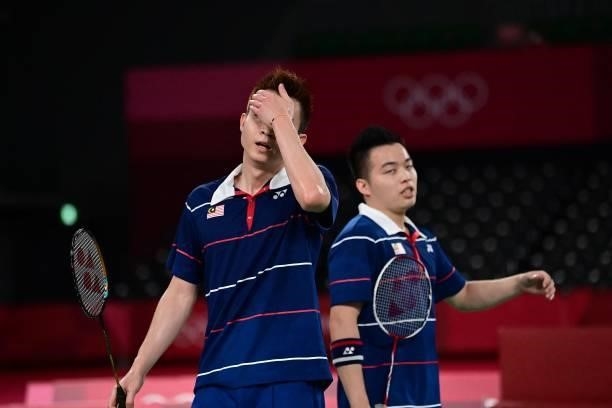 Malaysia's Soh Wooi Yik and Malaysia's Aaron Chia react after a point in their men's doubles badminton semi-final match against China's Liu Yuchen...