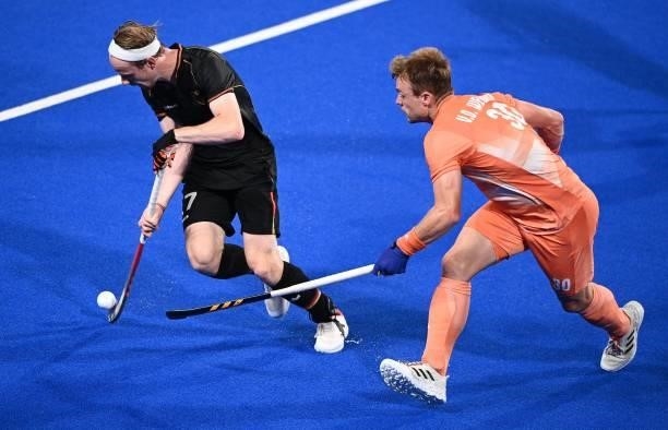 Germany's Jan Christopher Ruhr is tackles by Netherlands' Mink Alphons Louis Van Der Weerden vie for the ball during their men's pool B match of the...
