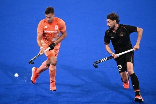 Netherlands' Sander Sebastiaan Robert De Wijn is challenged by Germany's Florian Fuchs during their men's pool B match of the Tokyo 2020 Olympic...