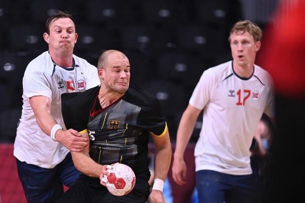 Germany's left back Paul Drux is challenged by Norway's left back Sander Sagosen past Norway's left wing Magnus Jondal during the men's preliminary...